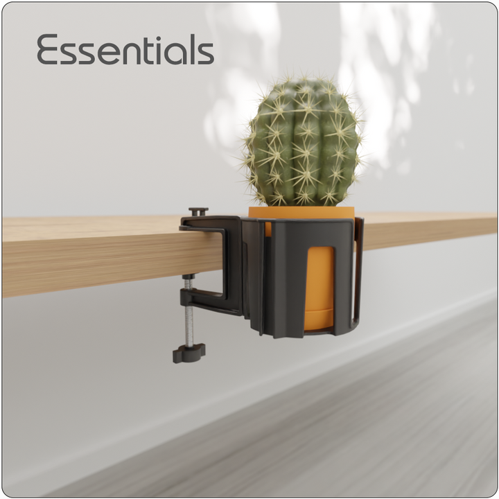 Cup-Holster holding a small potted plant on the side of a desk, used as a compact organizer for workspace accessories.